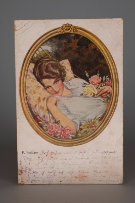 Postcard depicting young woman with flowers