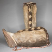 two sealskin boots, one is upright and the other is positioned on its side